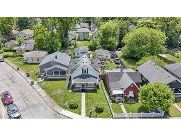 Charming homes showcase well-maintained lawns and mature trees in a peaceful residential neighborhood at 3636 Crescent Ave, Indianapolis, IN 46208