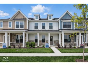 Charming townhome showcasing a well-manicured lawn and a welcoming front porch at 3931 Wren Dr, Brownsburg, IN 46112
