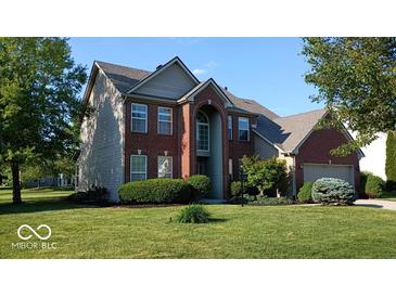 Beautiful two-story home with a well-maintained lawn and mature trees at 14170 Royalwood Dr, Fishers, IN 46037