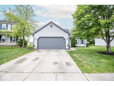 Charming one-story home with a two-car garage, a well-manicured lawn, and mature shade trees at 17841 Grassy Knoll Dr, Westfield, IN 46074