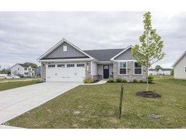 Charming single-Gathering home showcasing a well-manicured lawn, two car garage, and stone accents at 1863 River Birch Dr, Greenfield, IN 46140