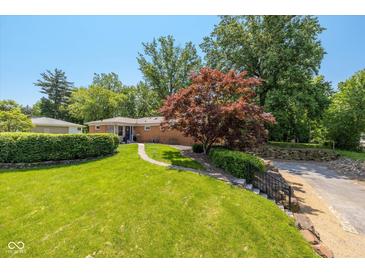 Well-maintained front yard with lush lawn, mature trees, and brick ranch-style home at 3105 E Banta Rd, Indianapolis, IN 46227