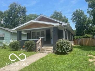 Charming one-story home featuring a cozy front porch and a well-maintained lawn at 4325 Norwaldo Ave, Indianapolis, IN 46205