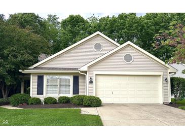 Charming single-story home with manicured lawn, attached two-car garage, and beautiful landscaping at 6366 Stratford N Dr, Fishers, IN 46038