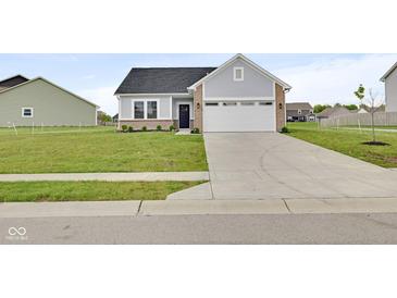 Charming single Gathering home with a large front yard and two car garage with ample parking at 637 N Quartz Ln, Fortville, IN 46040