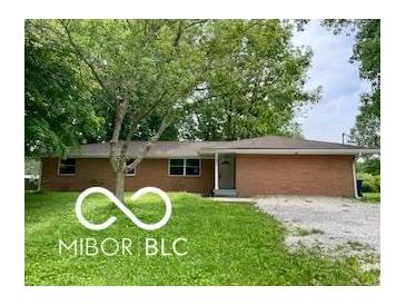 Charming single story brick home with a mature trees and a well-maintained lawn at 6373 E Hadley Rd, Mooresville, IN 46158