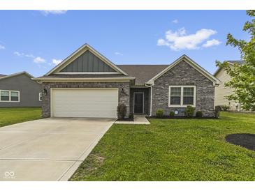 Charming one-story brick home with a well-manicured lawn, attached garage, and welcoming front entrance at 11815 Adair Pl, Indianapolis, IN 46229