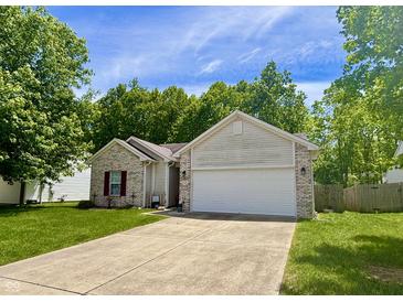 Charming exterior with brick accents, lush lawn, and attached two-car garage at 167 Hilltop Farms Blvd, New Whiteland, IN 46184