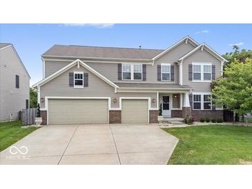 Charming two-story home with a three-car garage and well-manicured lawn at 19534 Forsythe Dr, Noblesville, IN 46060