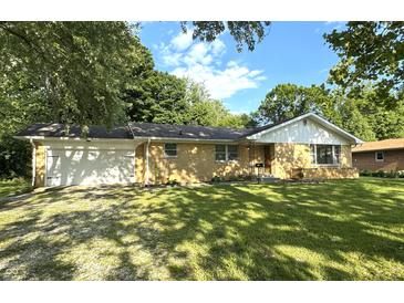 Charming brick ranch-style home with a well-manicured lawn and an attached one-car garage at 403 Us Highway 31 N, Greenwood, IN 46142
