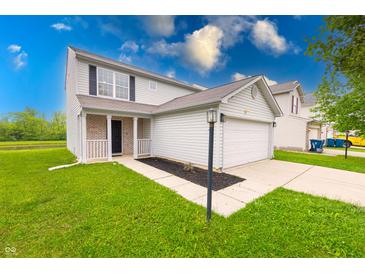 Charming two-story home with a well-manicured lawn and attached two-car garage at 4056 Orchard Valley Ln, Indianapolis, IN 46235