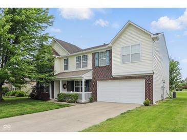 Charming two-story home featuring a two-car garage, well-maintained lawn, and inviting front porch at 6552 Hunters S Rdg, Zionsville, IN 46077