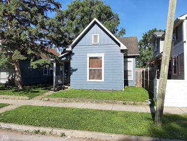 Charming single Gathering home featuring blue wood siding and mature shade tree at 764 Haugh St, Indianapolis, IN 46222