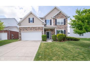 Charming two-story home with stone and siding, a two-car garage, and a well-manicured lawn at 8710 N Aspen Way, McCordsville, IN 46055