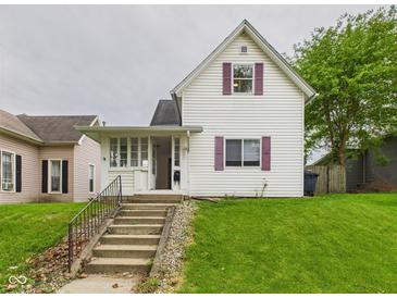 Charming two-story home with a front yard and concrete steps leading to the entrance at 907 S A St, Elwood, IN 46036
