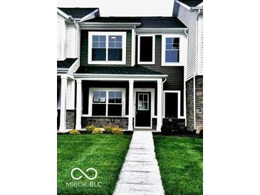 Charming two-story home with black shutters, well-maintained lawn, and front walkway at 19450 Northwest Dr, Westfield, IN 46074