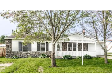 Charming single-story home with a stone facade and a welcoming front porch, surrounded by lush green landscaping at 315 Schoolhouse Rd, Franklin, IN 46131
