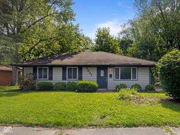 Charming single-story home featuring gray siding, dark shutters, and a lush green lawn at 3627 N Brentwood Ave, Indianapolis, IN 46235