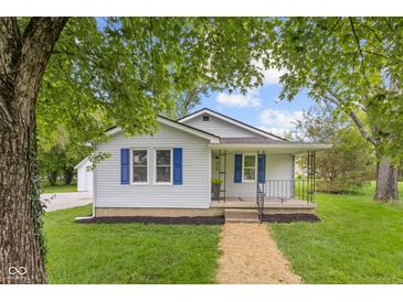 Charming home featuring blue shutters, well-maintained lawn, and inviting front porch at 425 Patterson Rd, Columbus, IN 47203