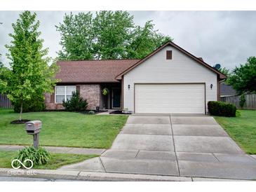 Charming single-story home with a well-manicured lawn and a two-car garage at 444 Austin Dr, Avon, IN 46123