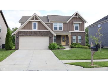 Charming two-story home featuring brick and siding, a two-car garage, and a well-manicured lawn at 9903 Deep Royal Way, Indianapolis, IN 46239