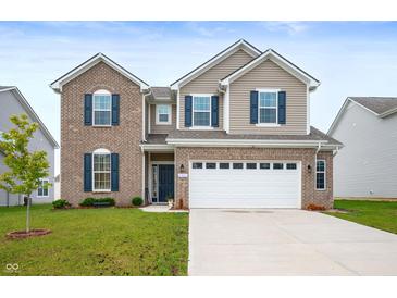 Charming two-story home with brick and vinyl siding, blue shutters, a manicured lawn, and a two car garage at 1065 Bent Branch Ln, Greenwood, IN 46143