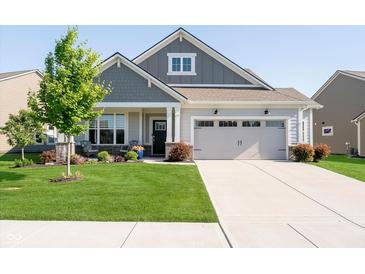 Charming single-Gathering home with manicured lawn, inviting front porch, and a two-car attached garage at 19581 Sumrall Pl, Westfield, IN 46074