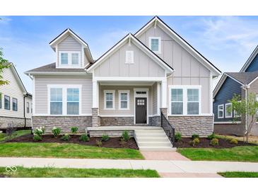 Charming home featuring a stone foundation, neutral siding, and a welcoming front porch at 19987 Old Dock Rd, Westfield, IN 46074