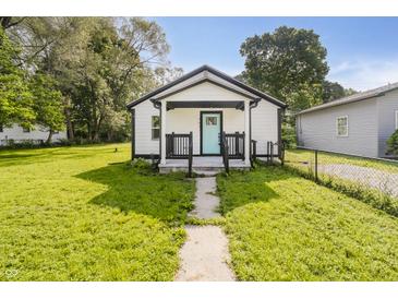 Charming single-story home featuring a quaint front porch and a well-manicured lawn at 2631 Collier St, Indianapolis, IN 46241