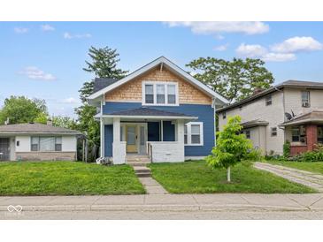 Charming two-story home with a welcoming porch and well-manicured lawn, creating a cozy curb appeal at 3227 Guilford Ave, Indianapolis, IN 46205