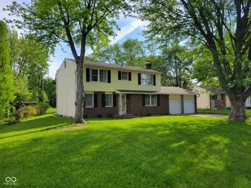 Charming two-story home featuring an attached two-car garage and a well-maintained lawn at 5515 Lunsford Dr, Indianapolis, IN 46237