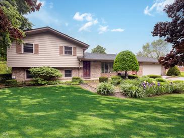 Charming two-story home with landscaped front yard and brick accents, creating a welcoming curb appeal at 5730 Teresa Dr, Alexandria, IN 46001