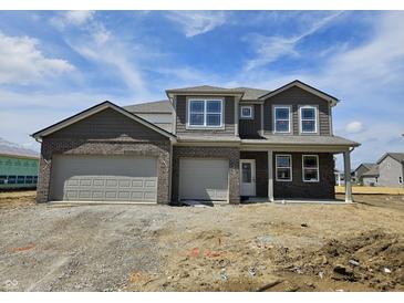 Two-story home featuring a two-car garage, brick and shingle siding, white trim, and professional design at 6032 Granby Dr, Whitestown, IN 46075