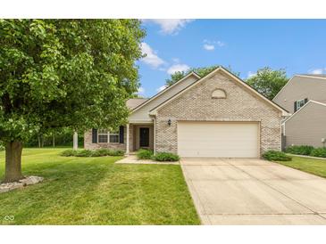 Charming brick home featuring an attached two-car garage and a well-maintained lawn and mature shade tree at 6369 Clary Ln, Greenwood, IN 46143