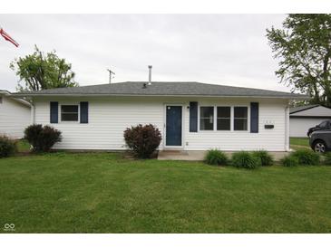 Charming single-story home featuring white siding, blue shutters and door, and a well-maintained lawn at 1021 Harney Dr, Lebanon, IN 46052