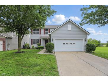Charming two-story home with a well-manicured lawn and a two-car garage at 10722 Landsbrook N Run, Noblesville, IN 46060