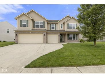 Inviting two-story home with a well-manicured lawn, three-car garage, and classic curb appeal at 11531 Short Iron Ln, Indianapolis, IN 46235