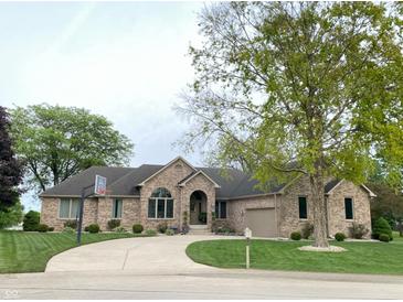 Beautiful brick home with a well-manicured lawn and curved driveway at 12231 Valley View Cir, Indianapolis, IN 46229