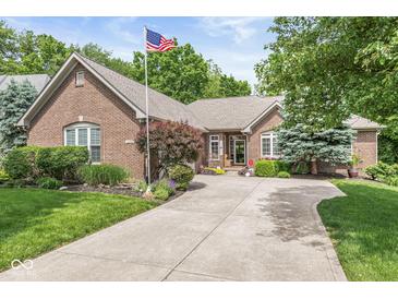 Charming brick home featuring mature trees, lush landscaping, and a welcoming front entrance at 18514 Oriental Oak Ct, Noblesville, IN 46062