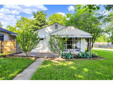 Charming single-Gathering home with a well-maintained lawn and inviting front porch at 1868 N Hawthorne Ln, Indianapolis, IN 46218