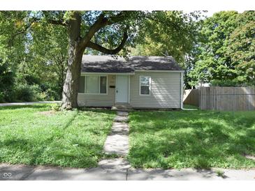 Charming single-story home with vinyl siding and a well-maintained front yard with mature trees at 1902 N Colorado Ave, Indianapolis, IN 46218