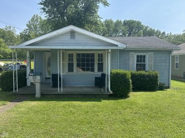 Charming single-story home with a covered front porch and well-maintained lawn at 2133 10Th St, Columbus, IN 47201