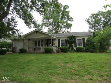 Charming single story home featuring a well-manicured lawn and a quaint front porch at 2825 Lucas Way, Columbus, IN 47203