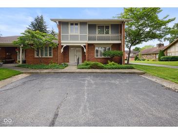 Inviting brick home with balcony and well-kept greenery, offering comfortable living at 3975 Offshore Dr, Columbus, IN 47203