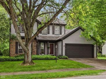 Charming two-story home with gray siding, brick accents, and a well-manicured front yard at 4736 Rocky Knob Ln, Indianapolis, IN 46254