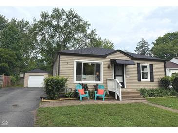 Charming single-story home featuring tidy landscaping and detached garage at 5348 Crittenden Ave, Indianapolis, IN 46220