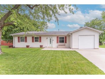 Charming home featuring a one-car garage, red shutters, and a well-maintained lawn at 5602 Northport Dr, Indianapolis, IN 46221