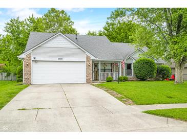 Charming single-story home with a well-manicured lawn and a welcoming porch at 6737 Raritan Dr, Indianapolis, IN 46221