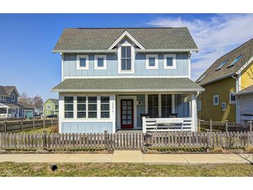 Charming two-story home with light blue siding, inviting front porch, and well-maintained landscaping at 10479 Dusty Rose Dr, Zionsville, IN 46077