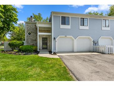 Charming townhouse with blue siding, stone accents, and attached two-car garage, perfect for comfortable living at 150 Dominion Dr, Zionsville, IN 46077